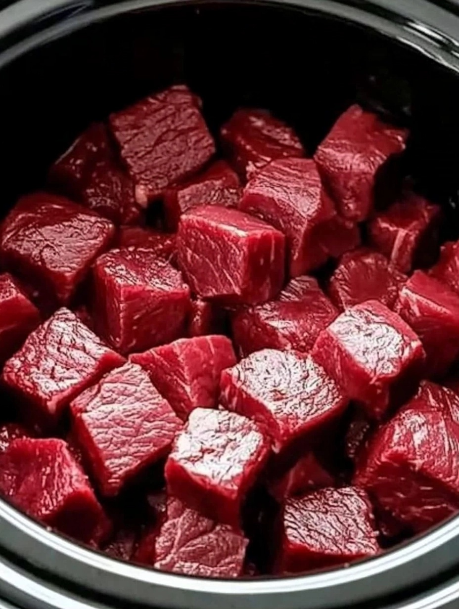 Put raw cubed beef in a slow cooker