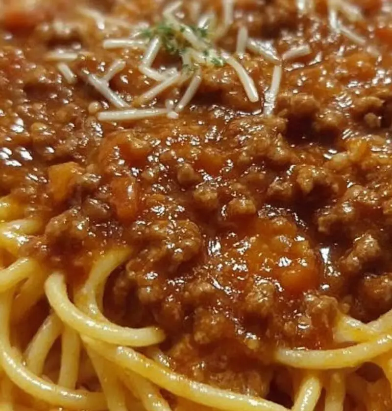 Serve the Bolognese sauce over the cooked spaghetti and top with freshly grated Parmesan cheese.